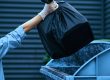 Valet trash service in South Florida: a porter collecting bagged trash from an apartment doorstep